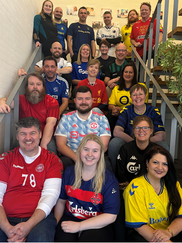 Picture of all employees wearing jerseys